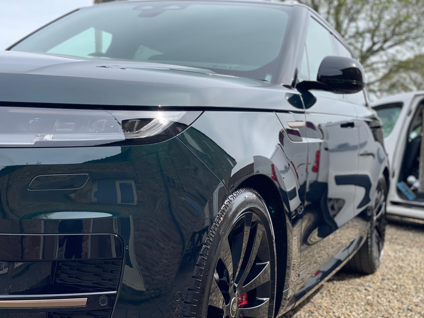 a black range rover parked in graveled area
