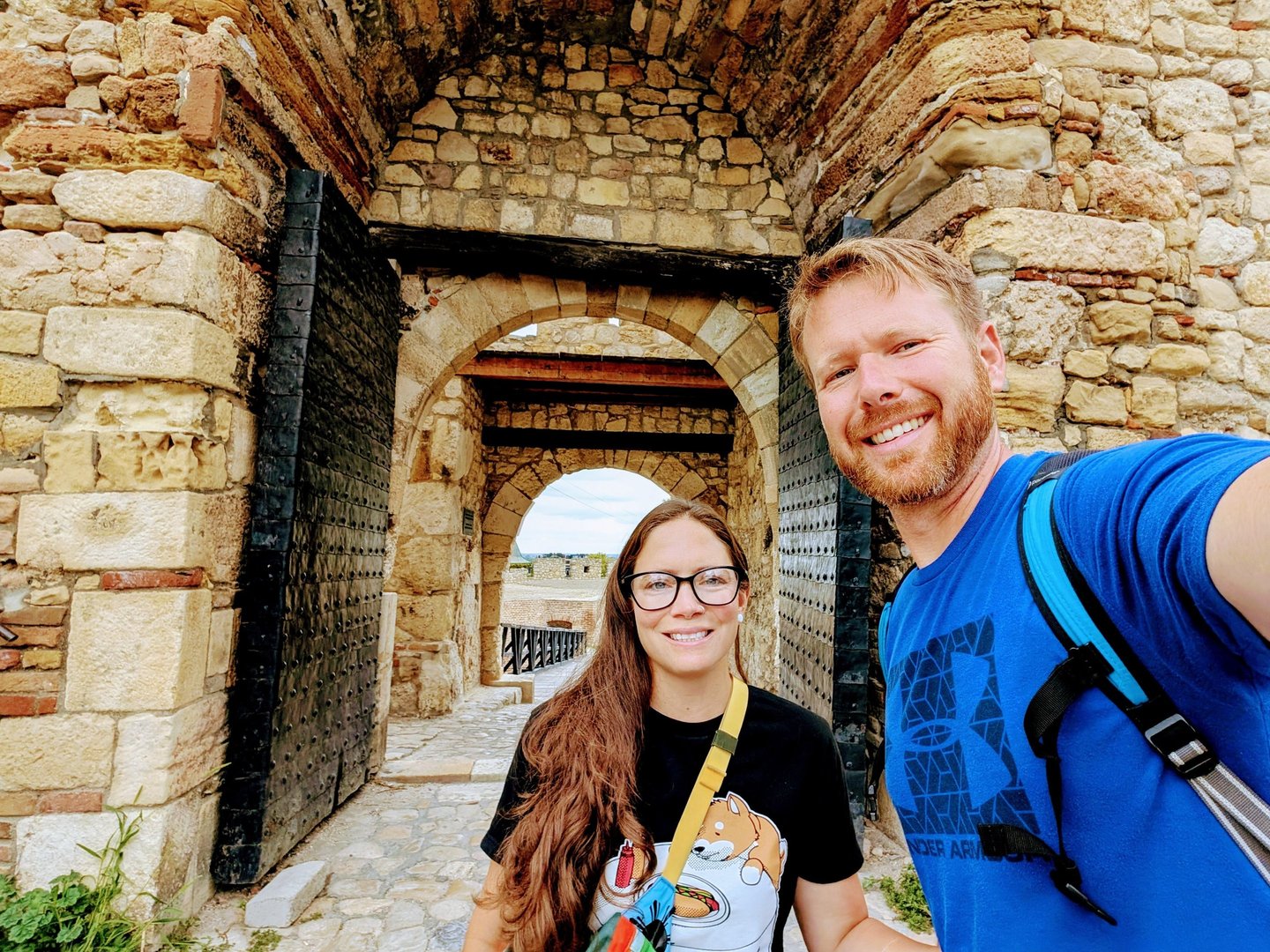 Moose and Bugs selfie in front of the historic stone gates of the ancient Kalemegdan Fortress in Belgrade.
