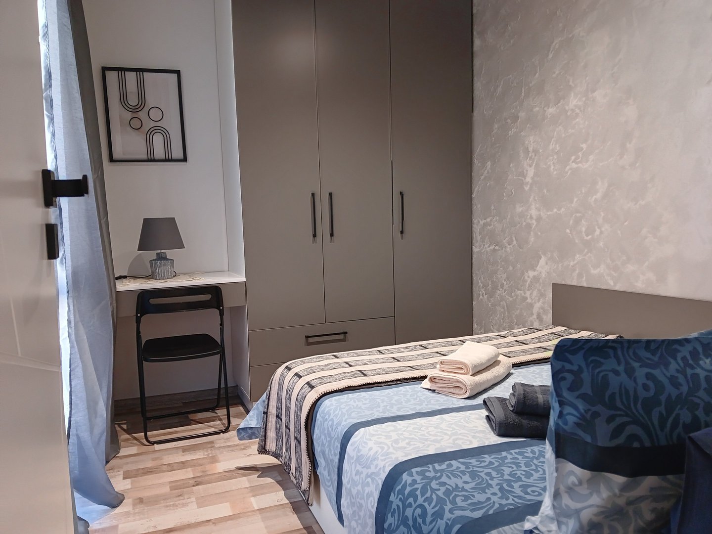 alt="Bijoux Apartment bedroom with cozy bed and modern decor"