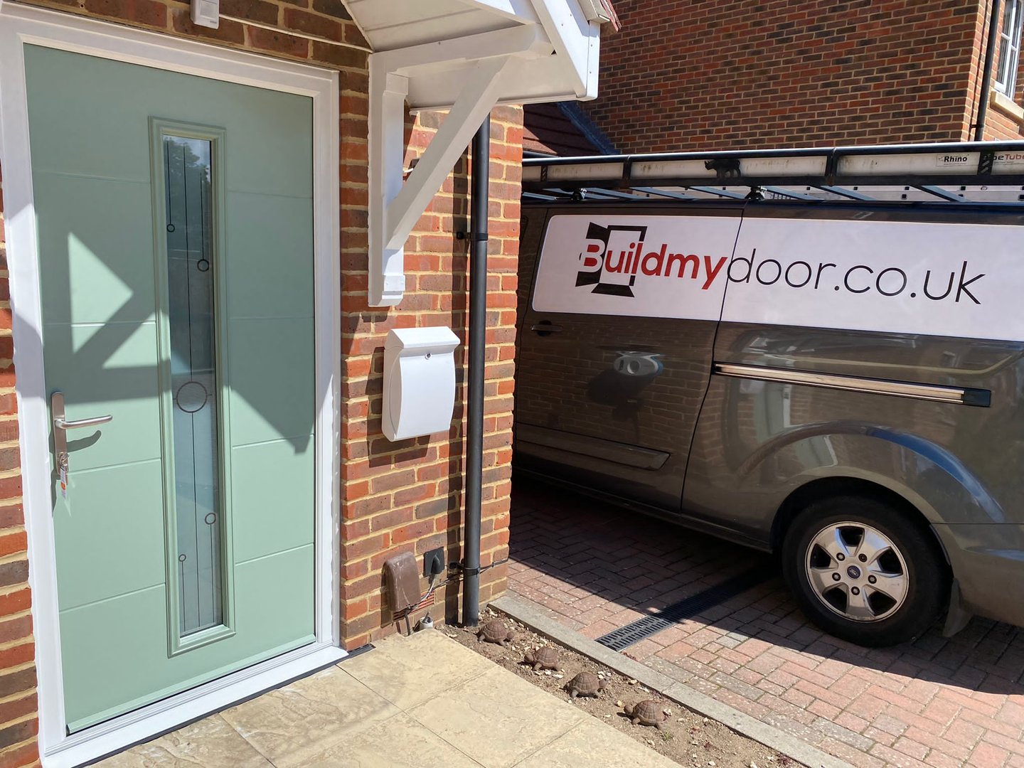 a chart well green front door with long glass panel and the buildmydoor van
