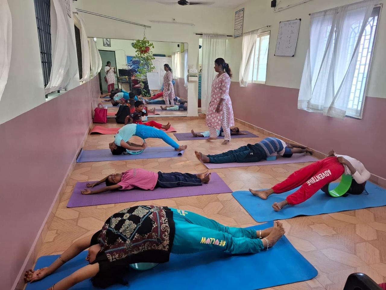 a group of people doing yoga exercises on a mat