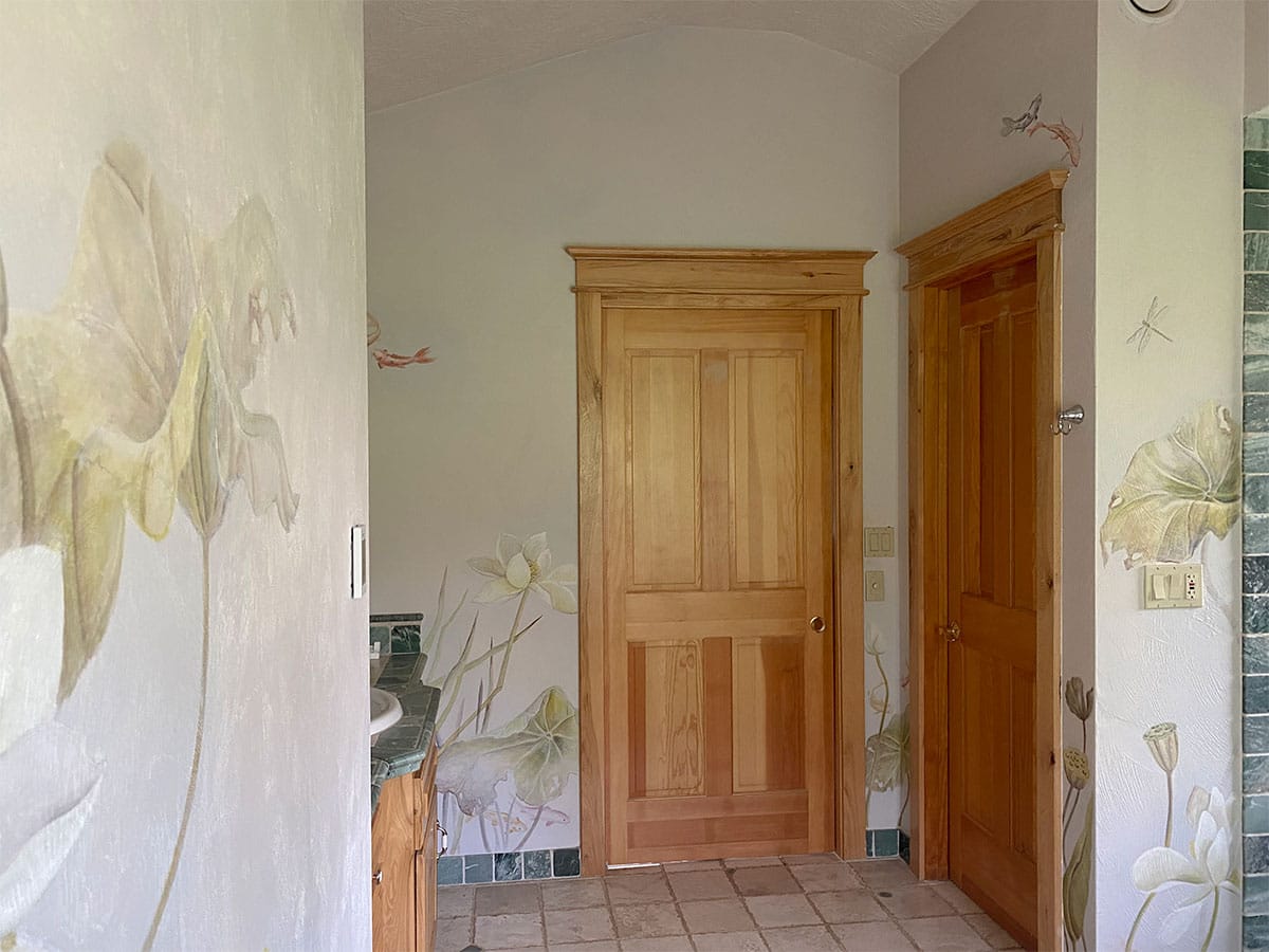 Luxury bathroom featuring painted murals of water lilies, koi and dragonflies in  watercolour and an Asian touch