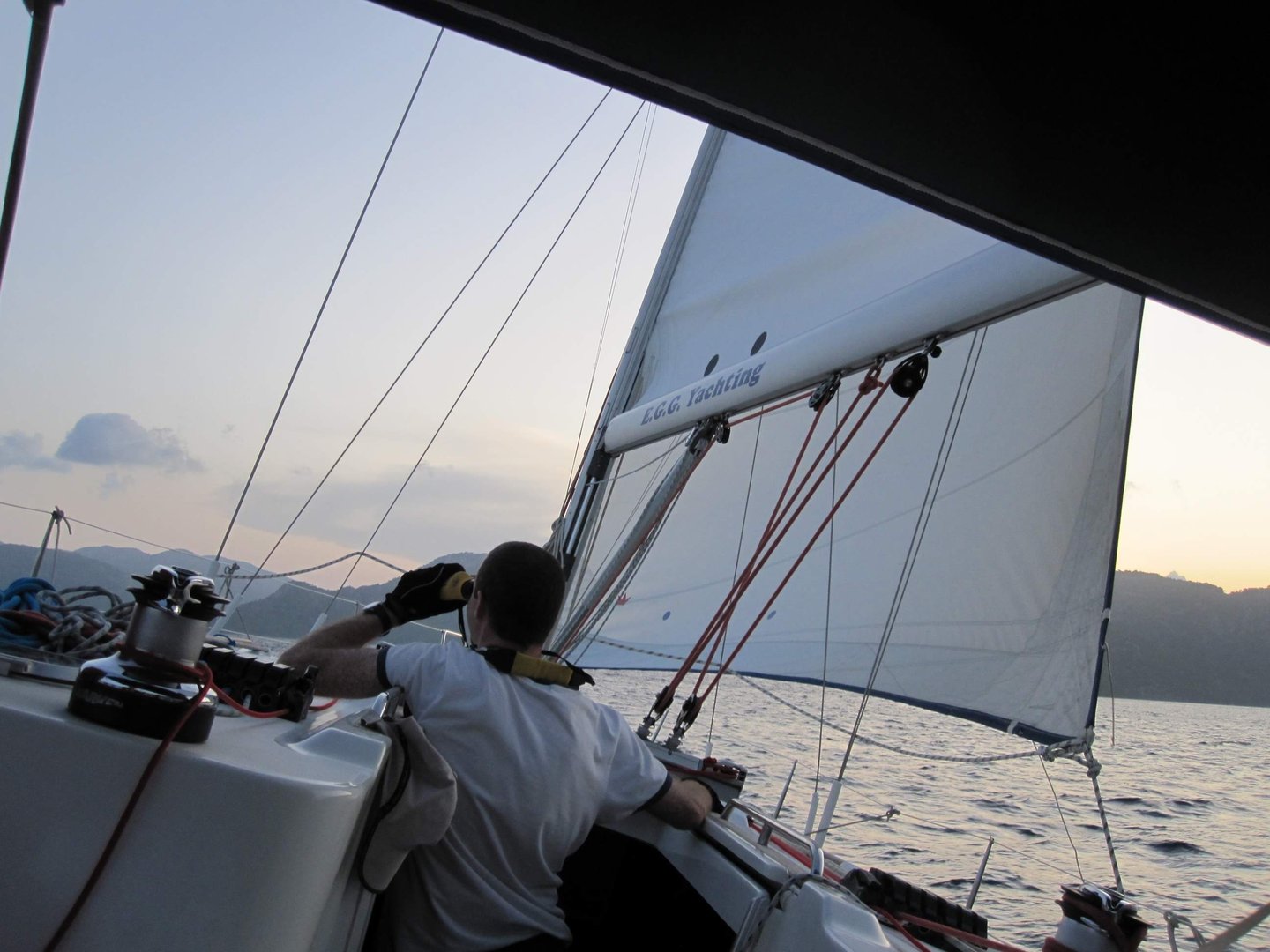 a man in a white shirt is sitting on a boat. Copyright Vincent Volpe