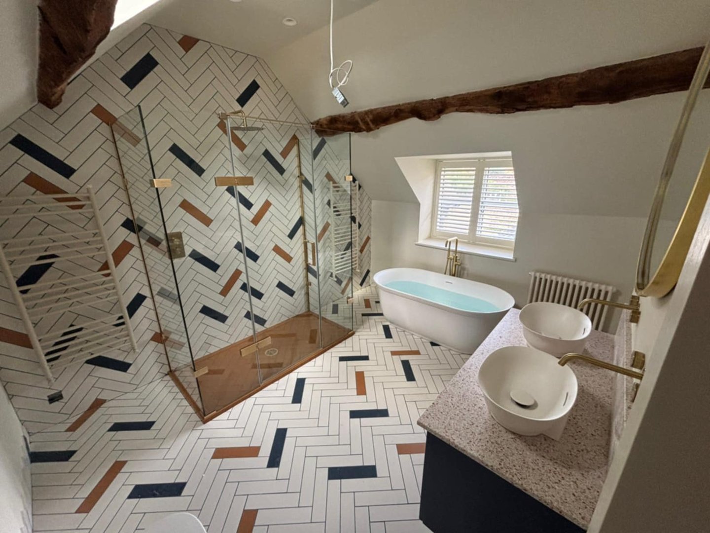 Modern bathroom installation with freestanding bath and tiled walls in Evesham