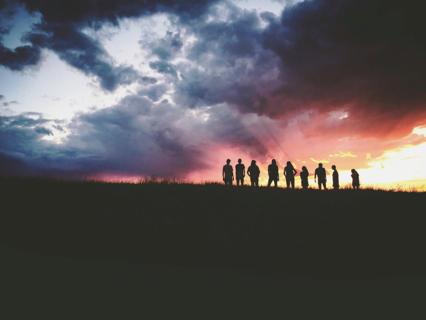 a group of people standing on a hill top