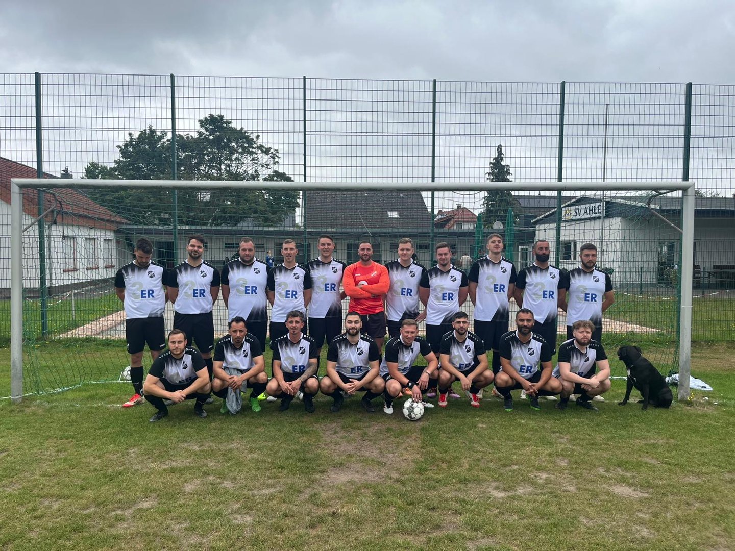 a group of men and women soccer players posing for a photo