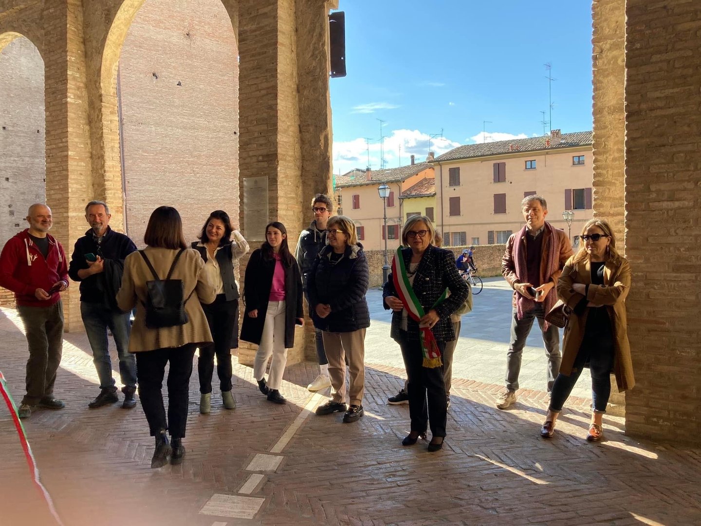 a group of people standing in a line of arches