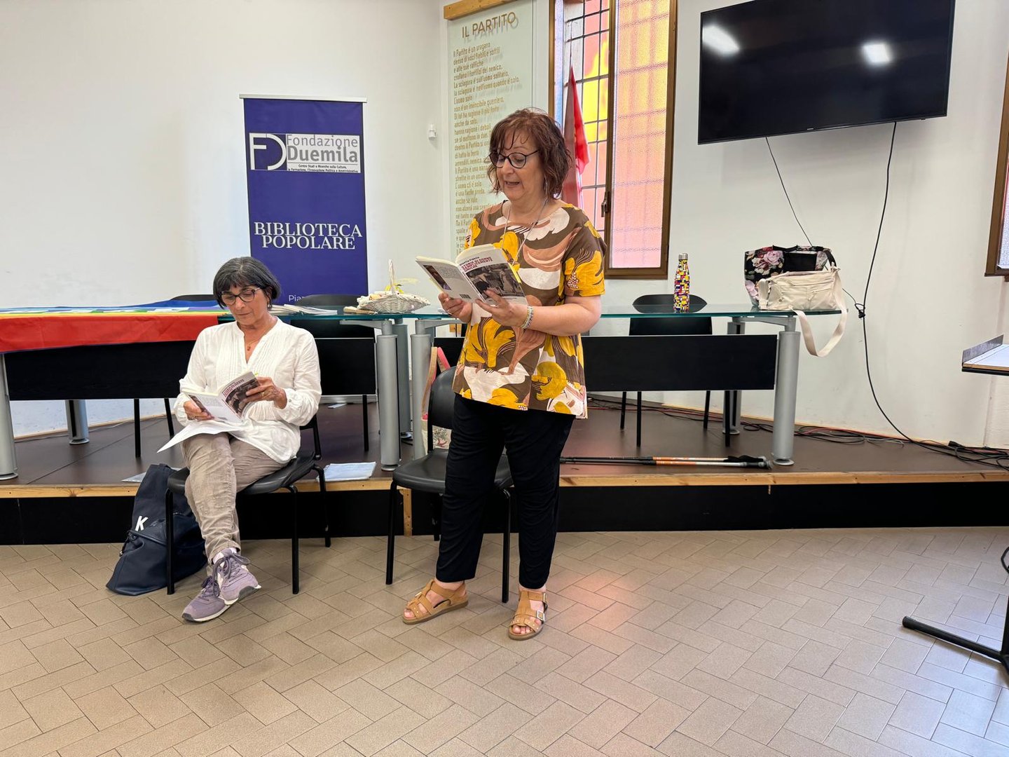 a woman in a yellow dress is reading a newspaper