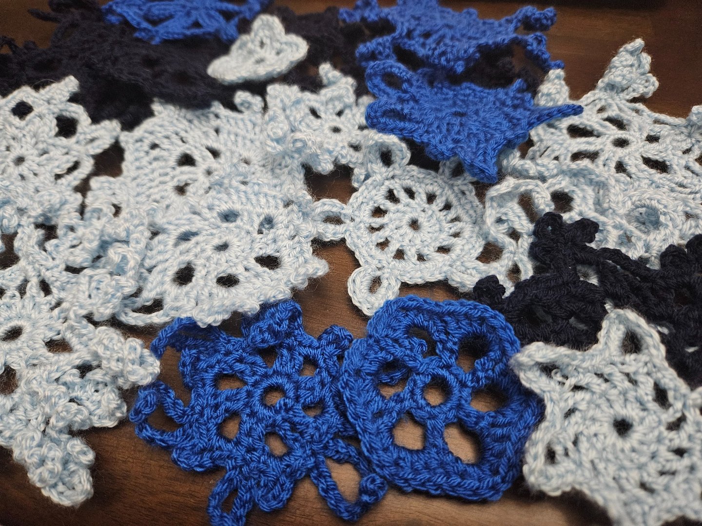 crochet snowflakes on a wooden table