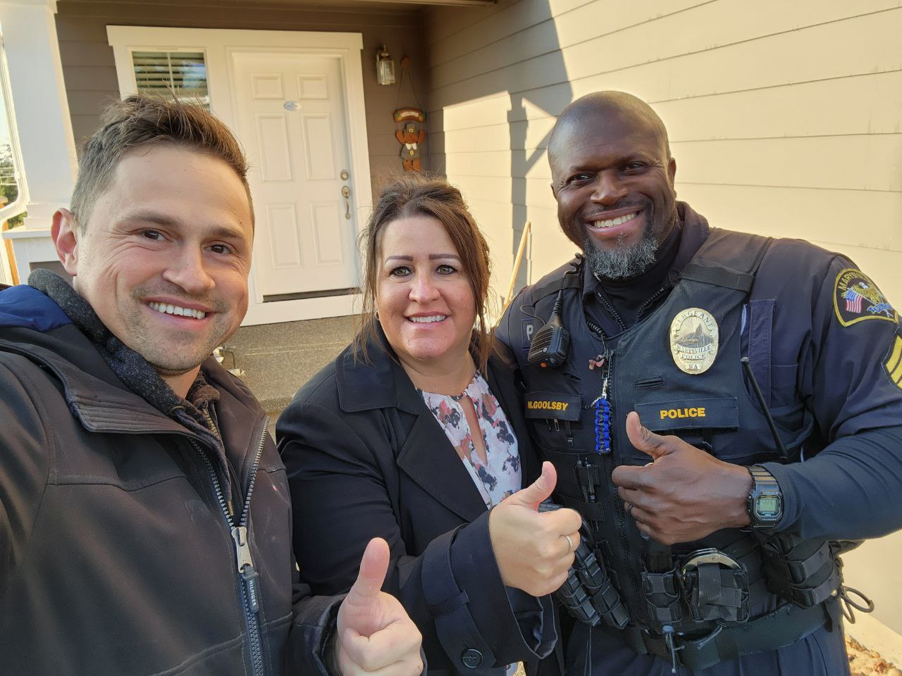 Marysville home owners next to their home. Water damage hardwood flooring. Floor buckling repair and restoration
