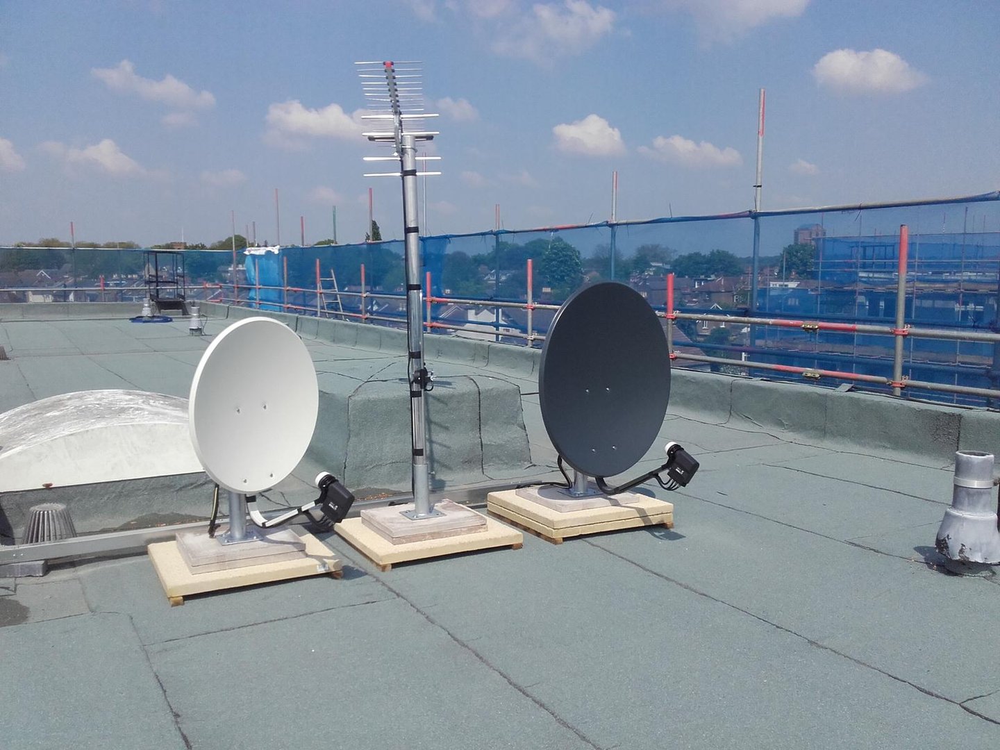 Rooftop TV aerial and dual satellite dish