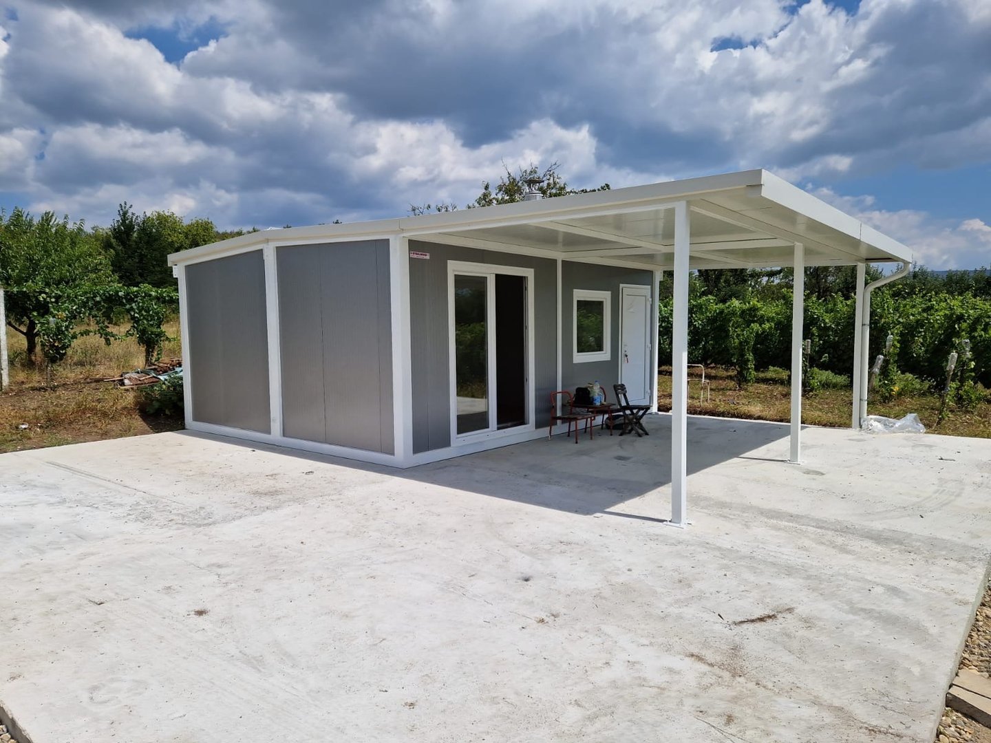 Stambeni sivi kontejner sa kosim krovom i nadstresnicom Nis