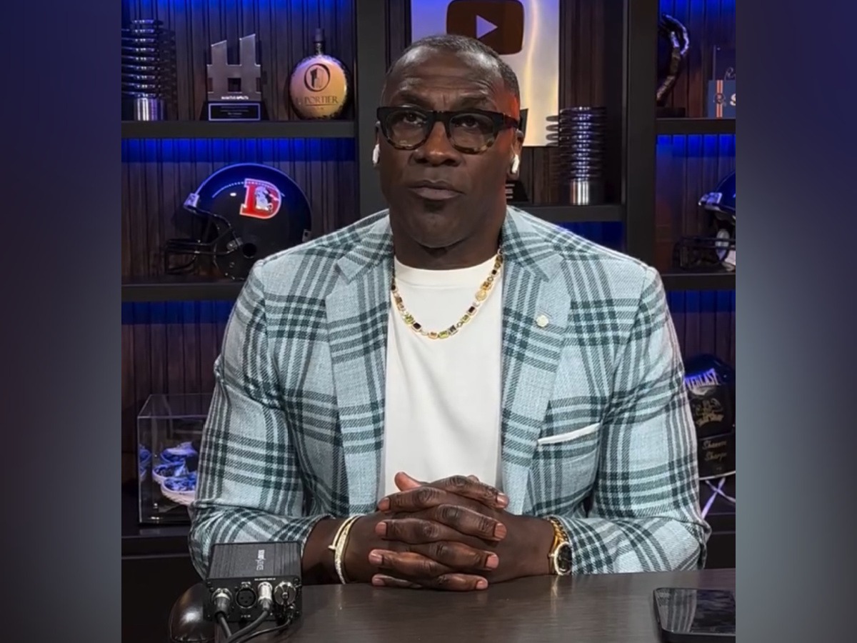 a man in a white shirt and a plaid blazer