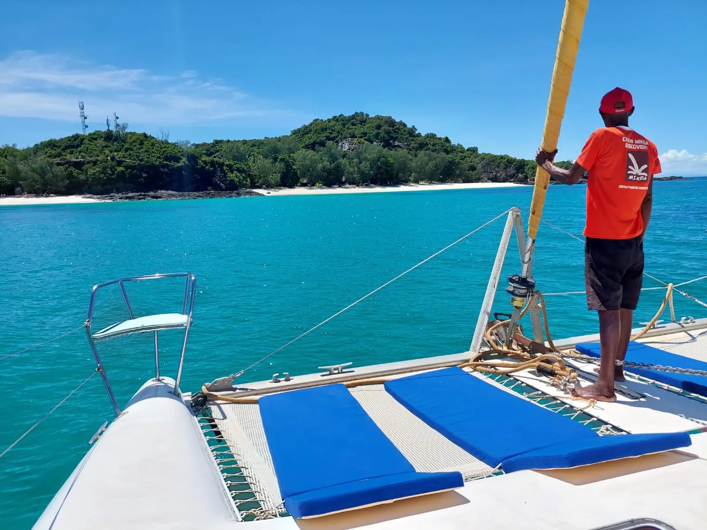 a man standing on a boat in the Nosy Be