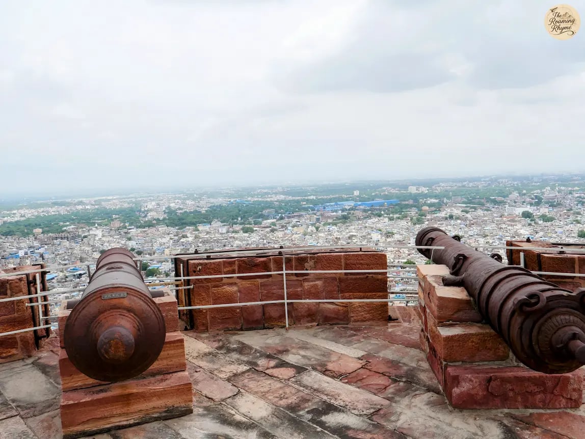 Aligned cannons on the ramparts of Mehrangarh Fort Jodhpur overlooking the panoramic Blue City view.
