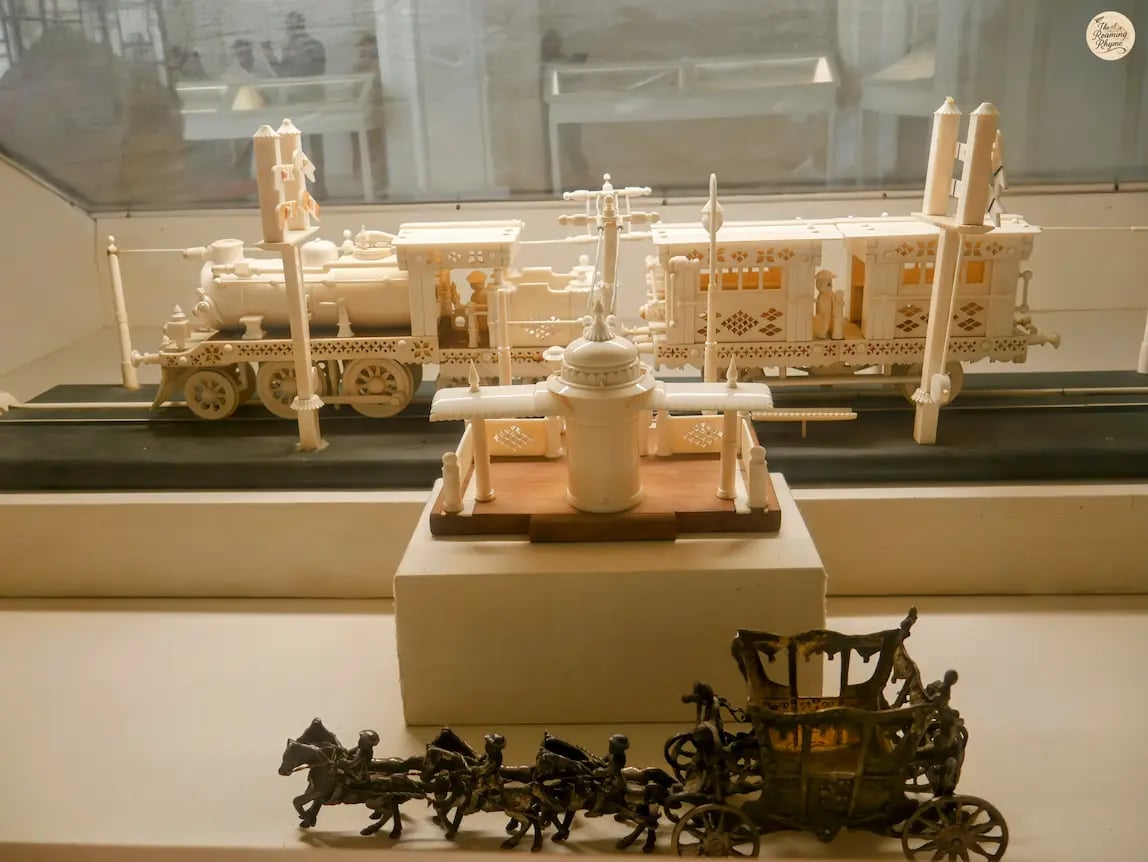 Intricate ivory train model displayed in Jodhpur museum, showcasing fine royal artistry.