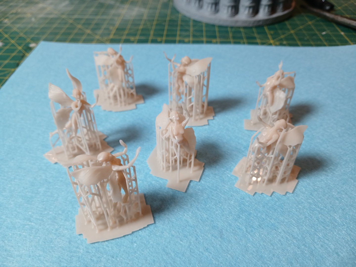 Fine detail resin fairy figures 3D printed with support structures as part of custom 3D sculptural services