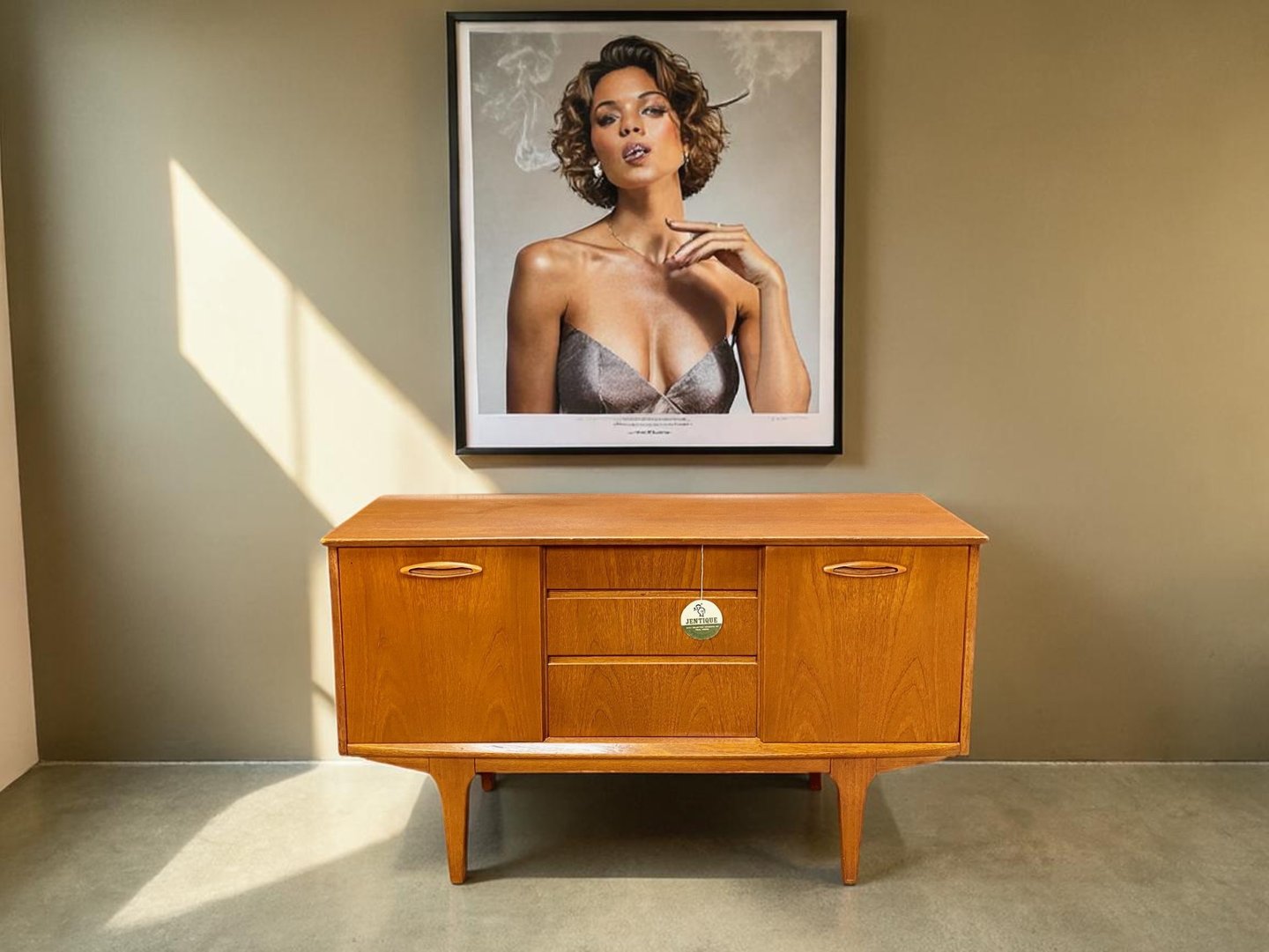 Small Jentique teak sideboard in Mid Century Modern style with compact storage and timeless retro design.