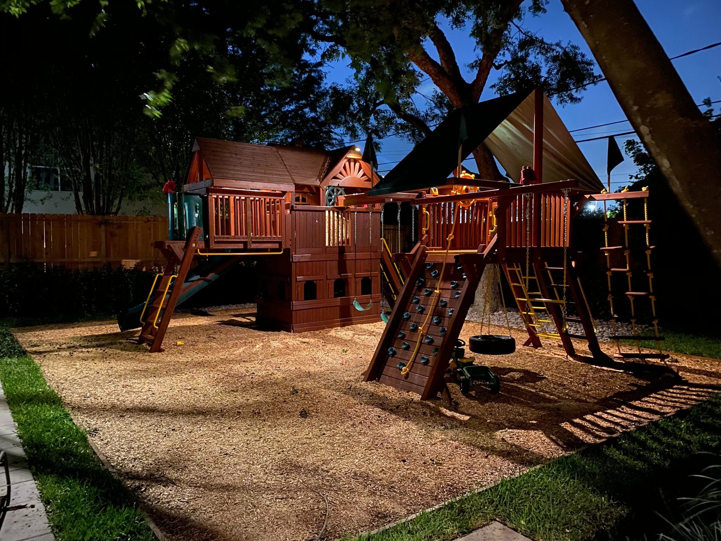 landscape lights installed on a swing set for a kids playground