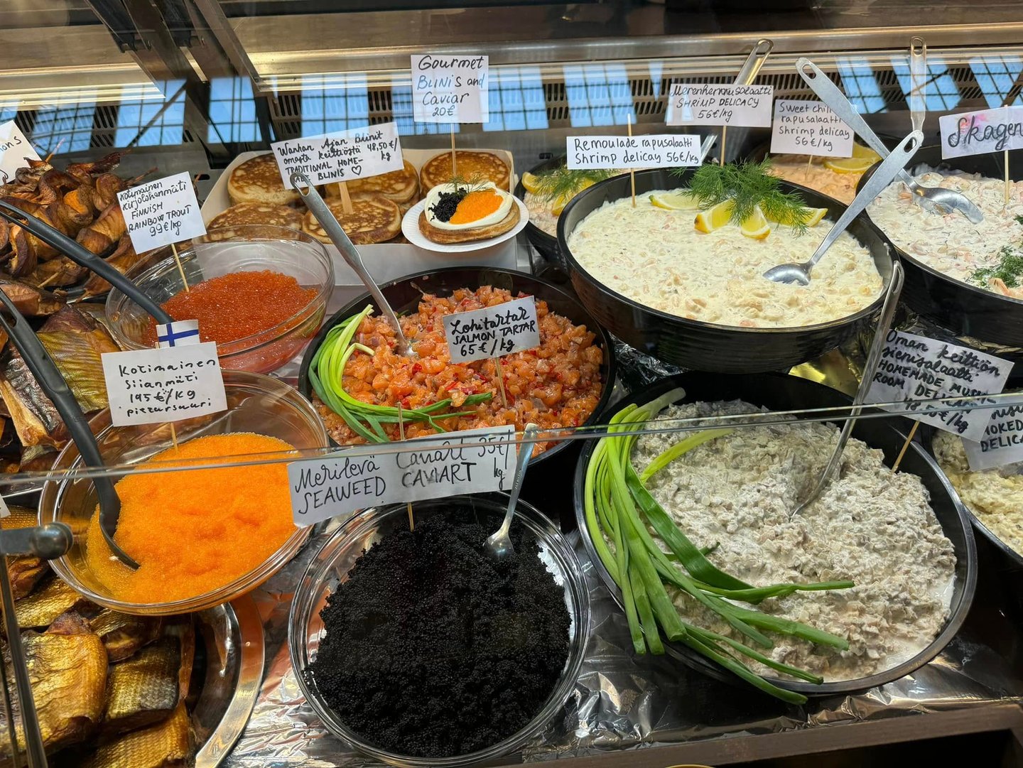 a variety of different types of food in a display case