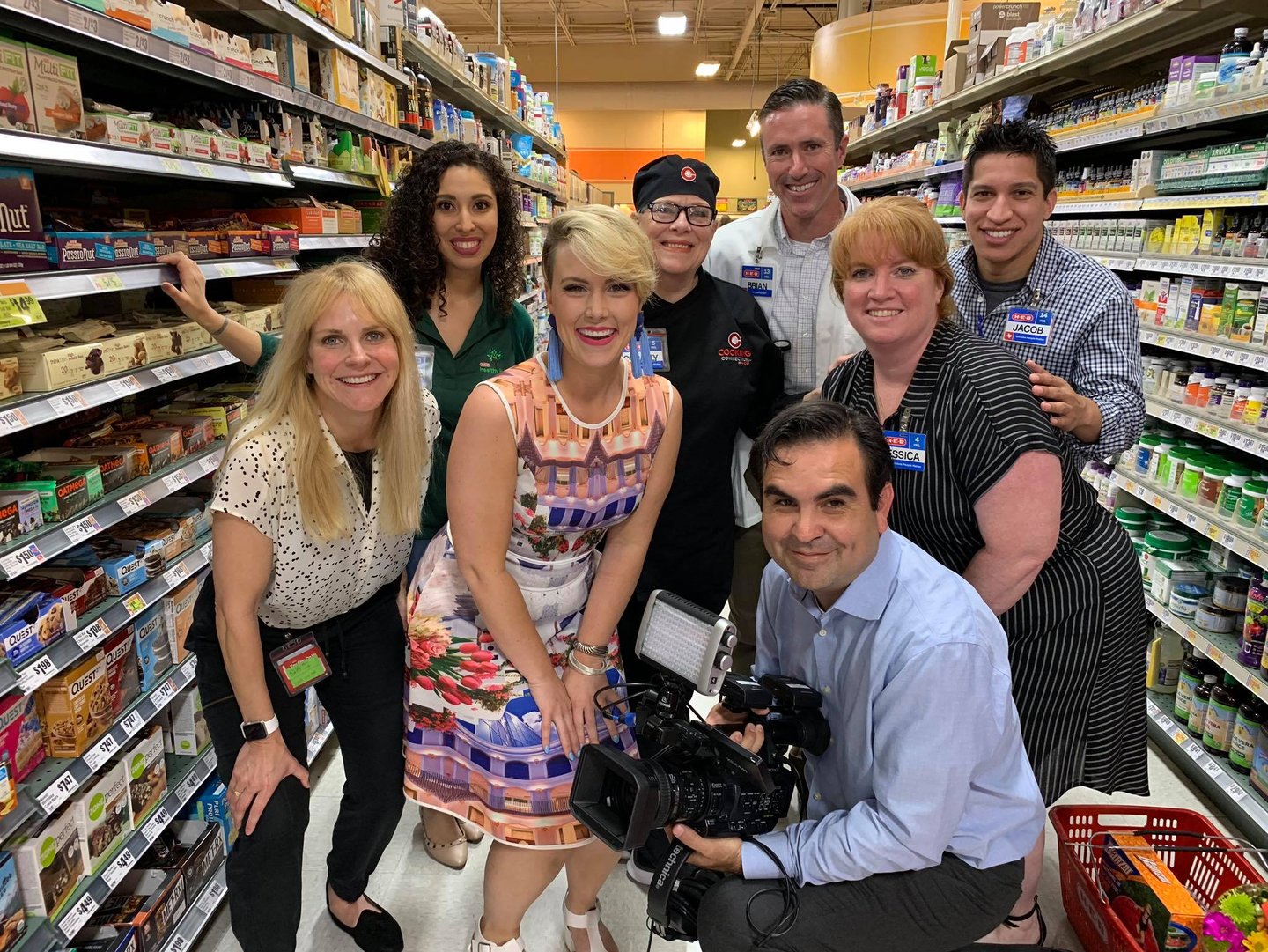 Francisco and Rosie Newbery at HEB, surrounded by talent, prepping to film a lively segment.