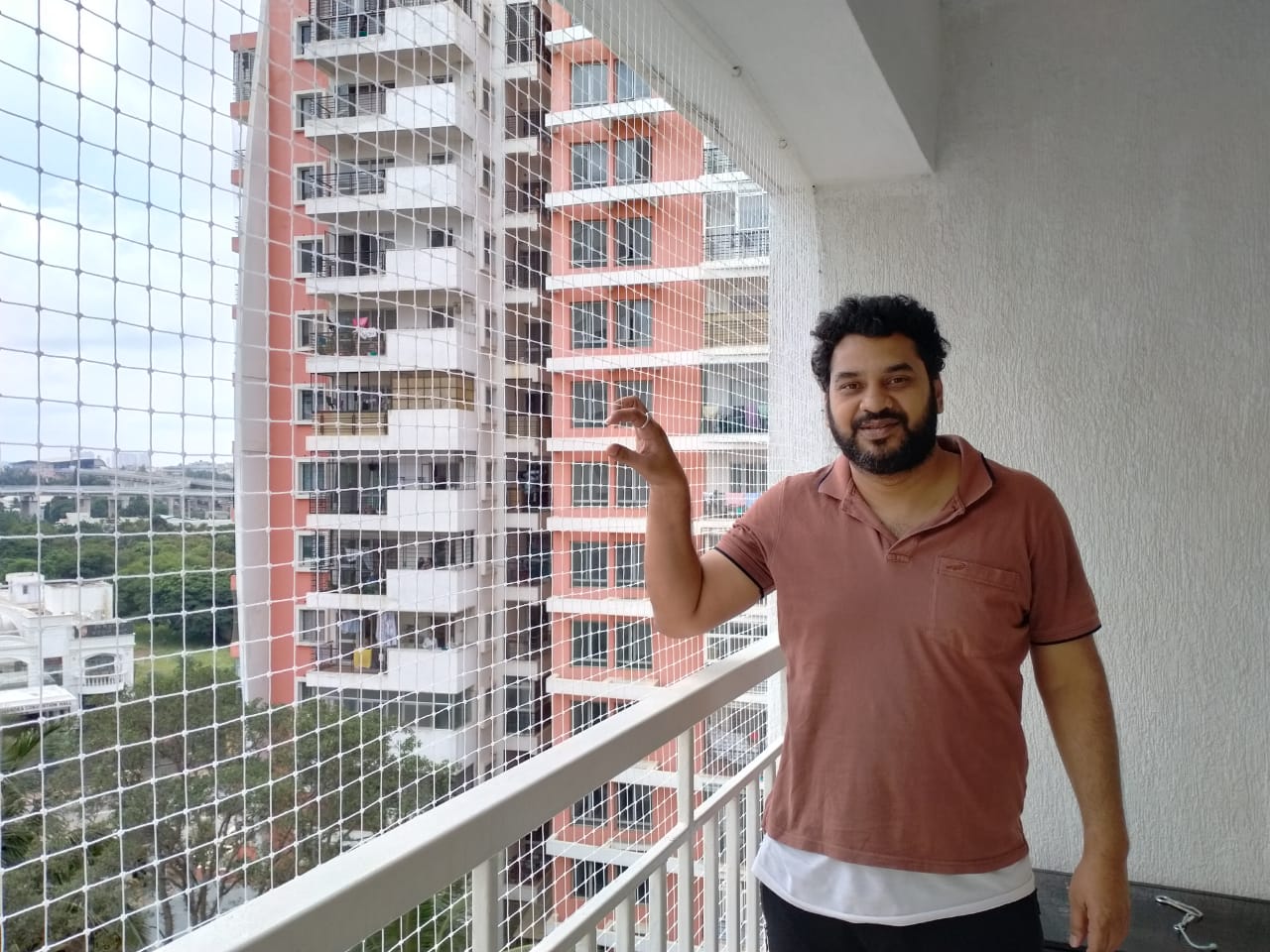 happy customer of arjilli safety nets in hsr layout inspecting the net