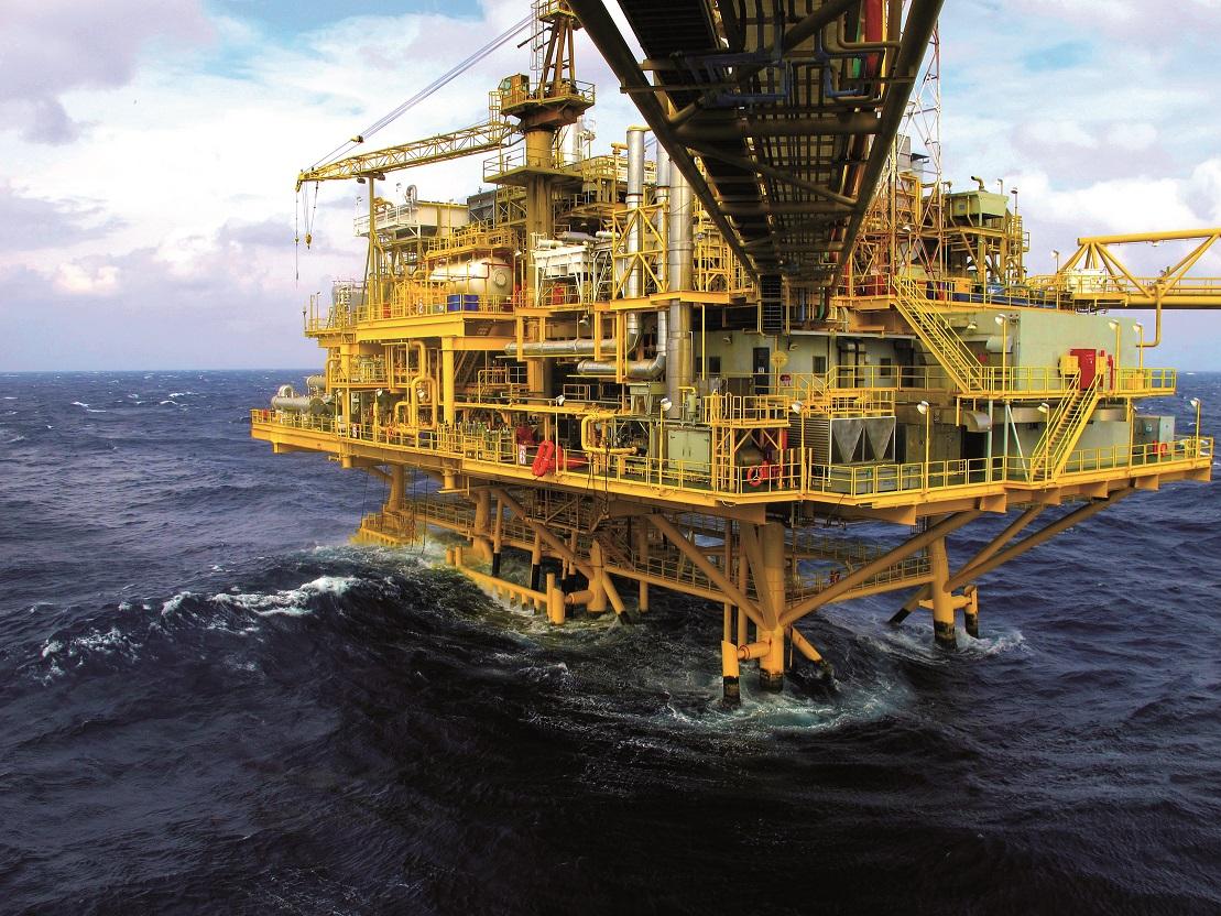 Offshore oil and gas drilling platform structure standing in deep ocean waters.