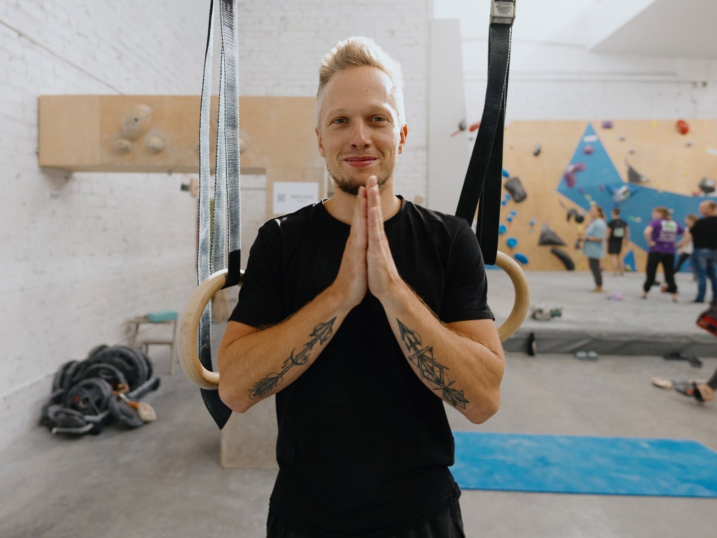 a man in a black shirt putting hands together
