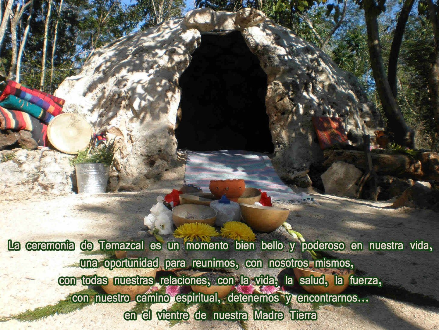 A traditional stone Temazcal sweat lodge with ceremonial items and Spanish spiritual text.