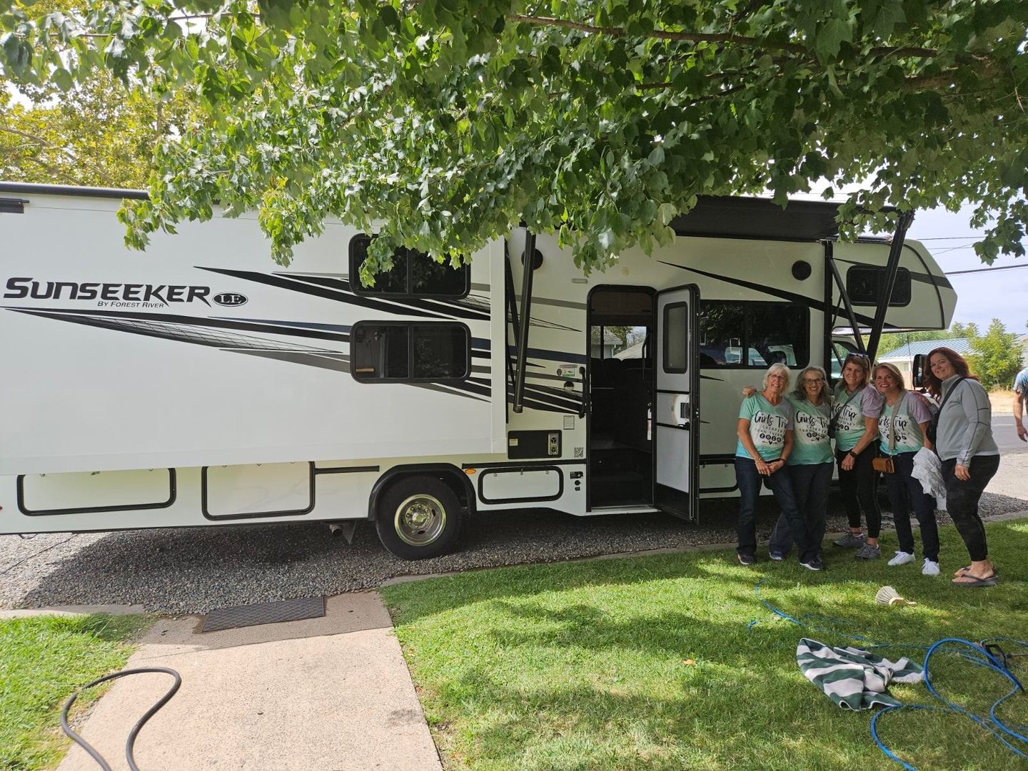 group of ladies in front of RV in matching shirts for their trip