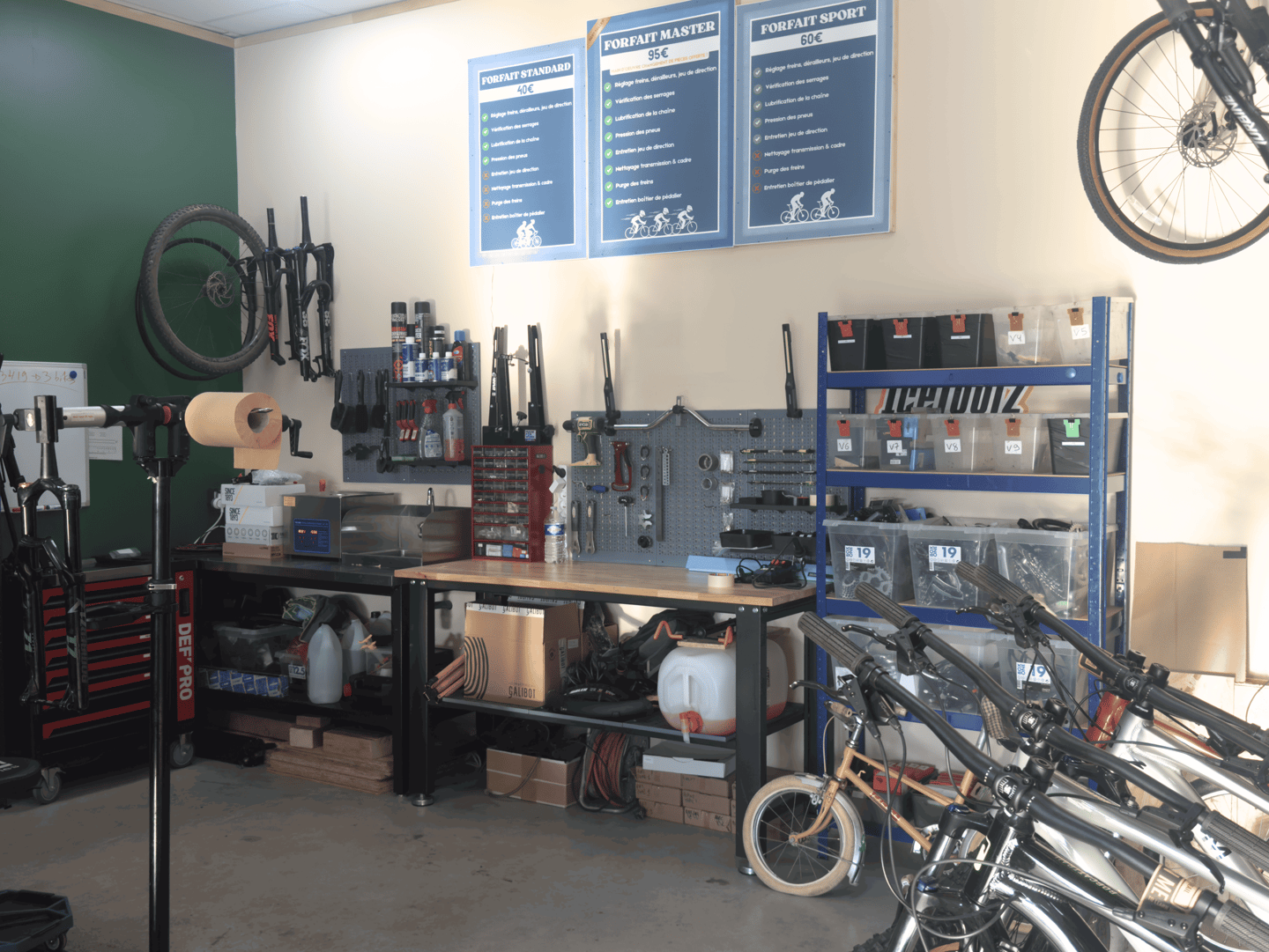 Professional bicycle repair workshop with tools, workbenches, and organized storage shelves.