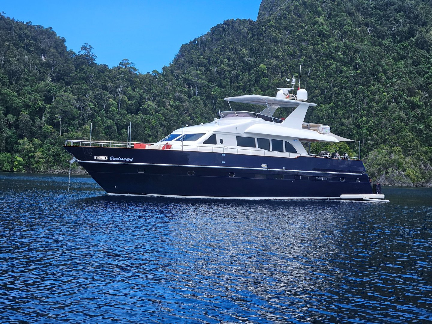 a boat on the water with a mountain in the background