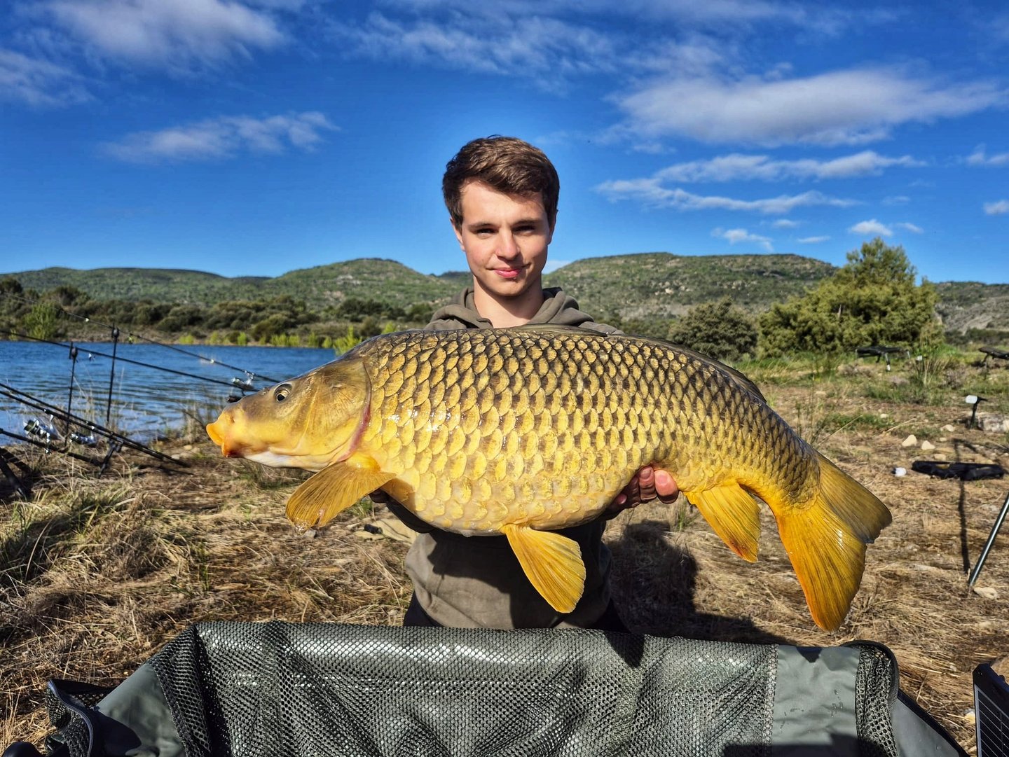 a man holding a fish carpel fish
