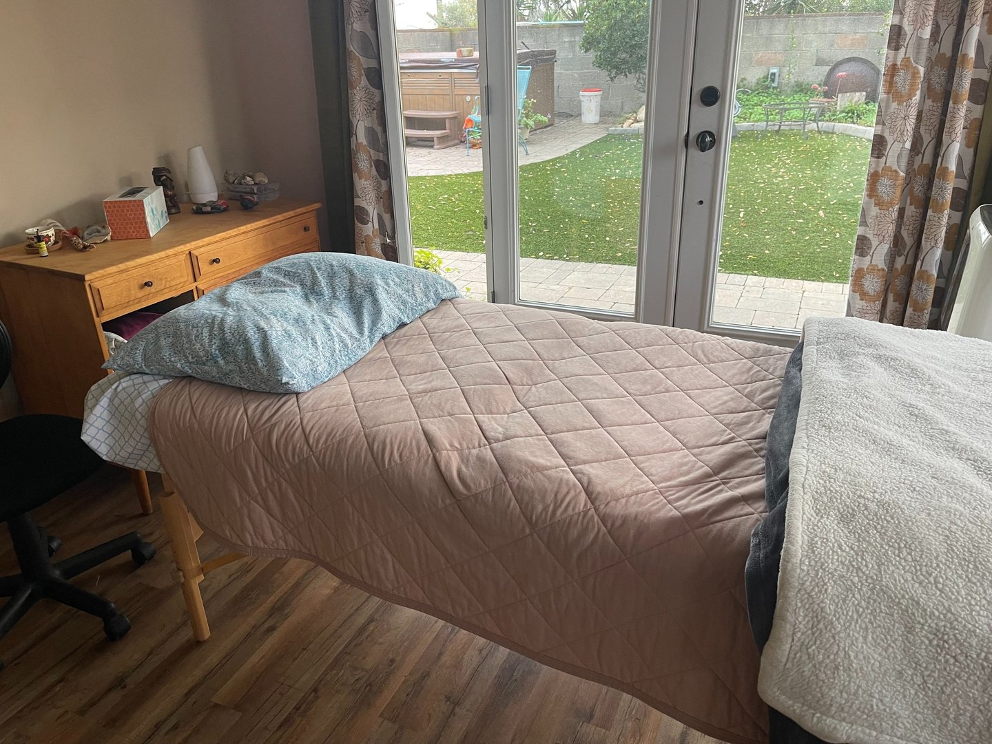 Massage table with pink blanket in a treatment room