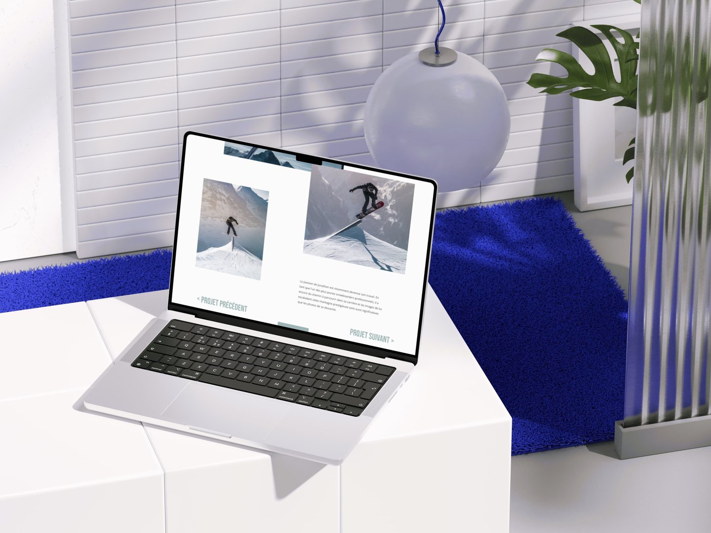 A modern laptop mockup displaying a portfolio website in a minimalist home office with blue accents.