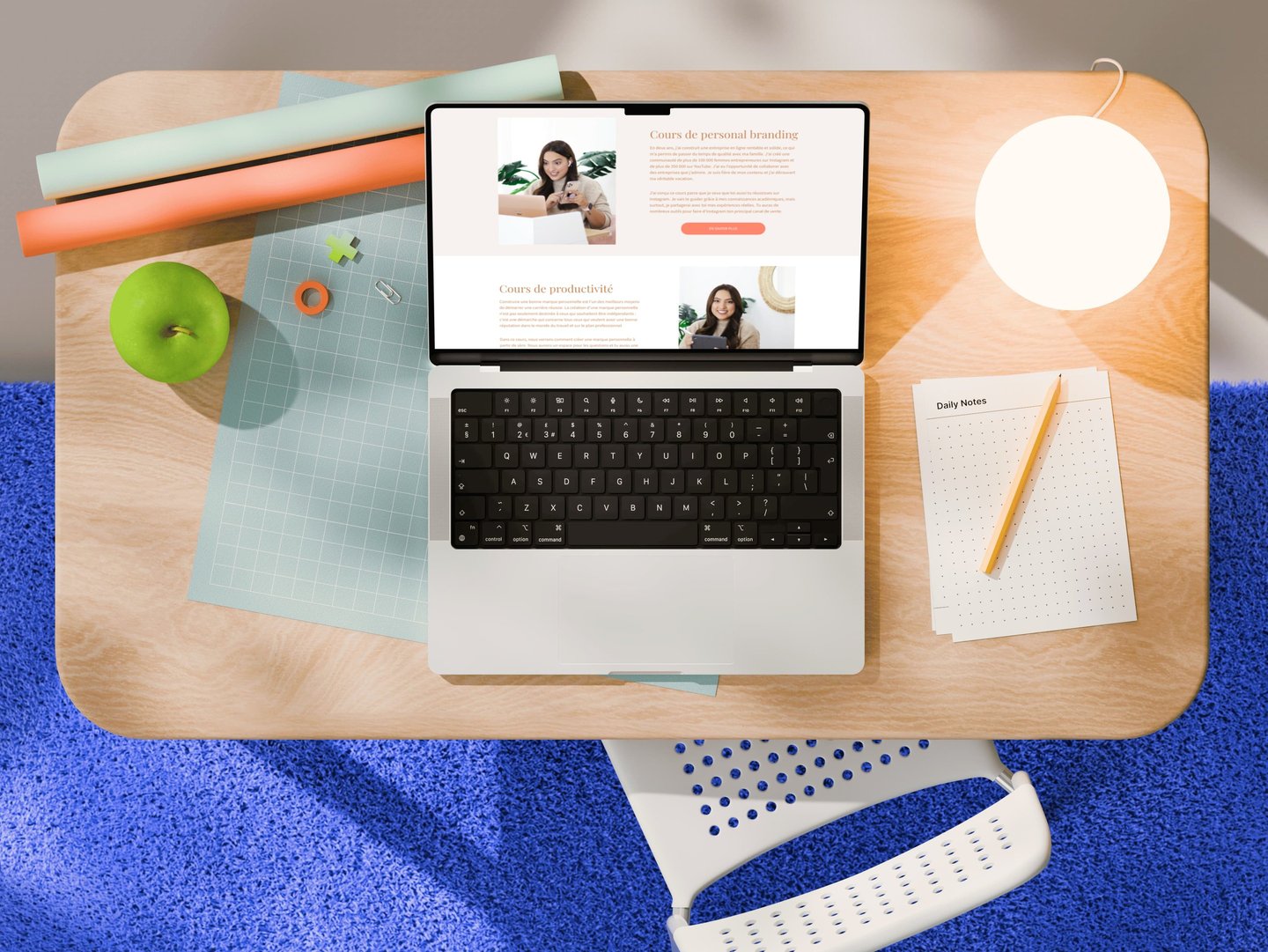 Top-down view of a laptop showing personal branding courses on a modern wooden desk with stationery.