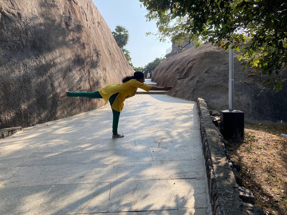 a woman in a yellow shirt is doing yoga