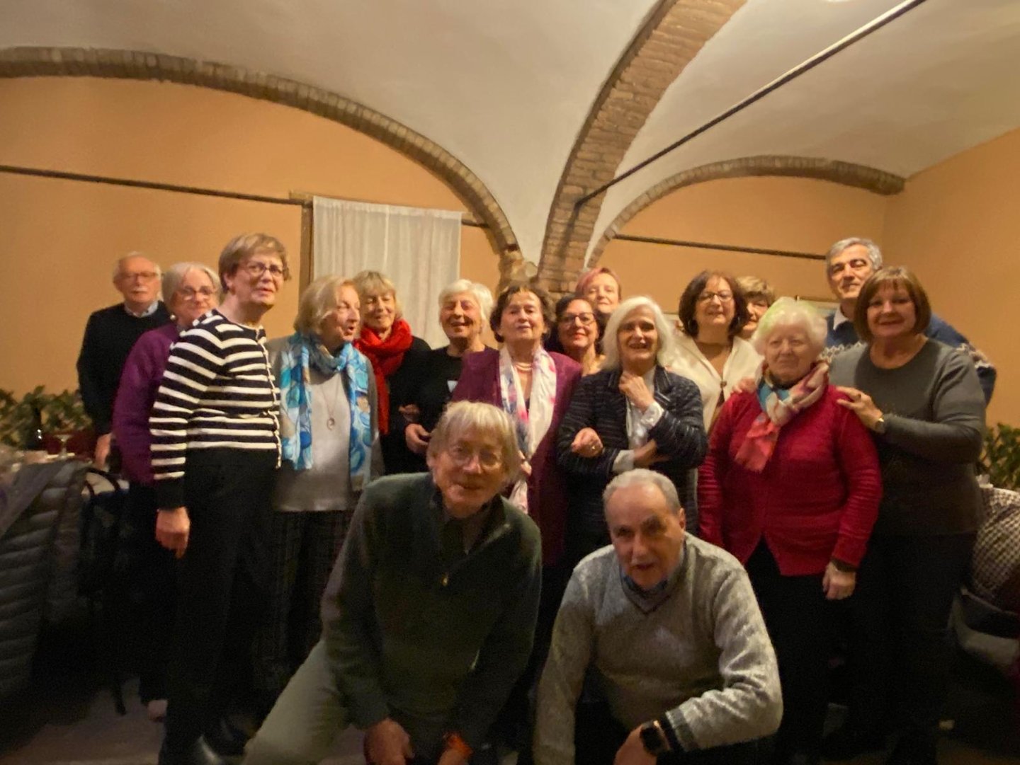 a group of people standing around a group of luggage bags