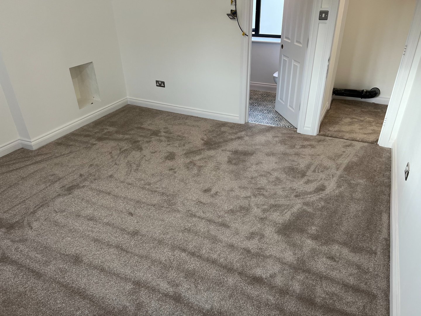 Carpeted bedroom flooring installation in Brighton Sussex, professional interior finish