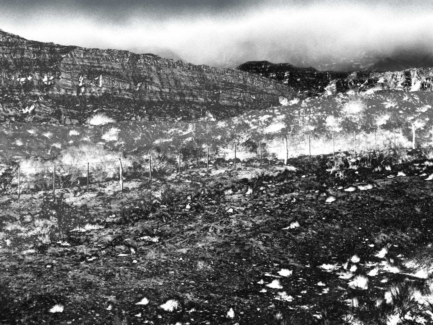 a black and white photo of a mountain scene