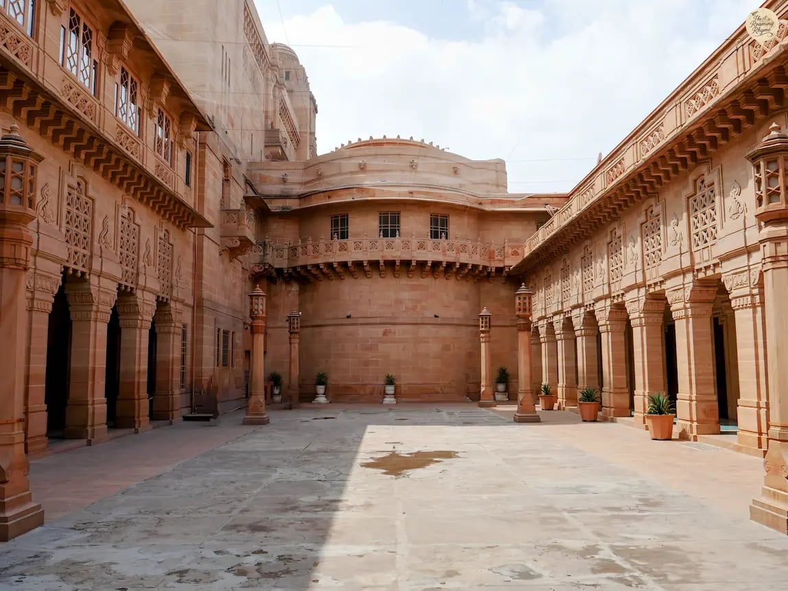 Beautiful red sandstone courtyard of Umaid Bhawan Palace in Jodhpur showcasing royal Rajasthani architecture.