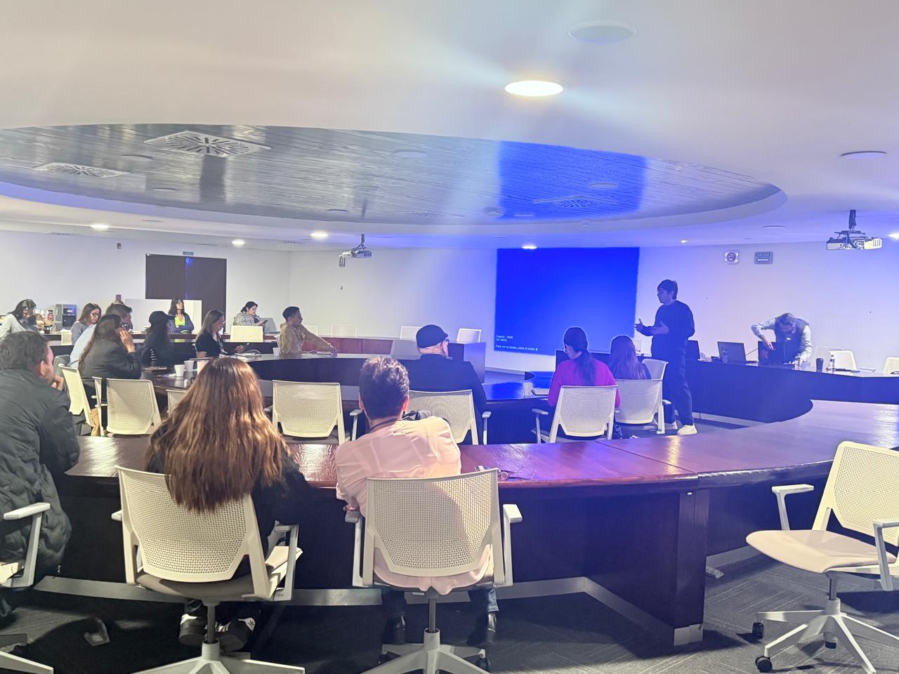 Professional workshop and seminar presentation in a modern conference room with attendees.