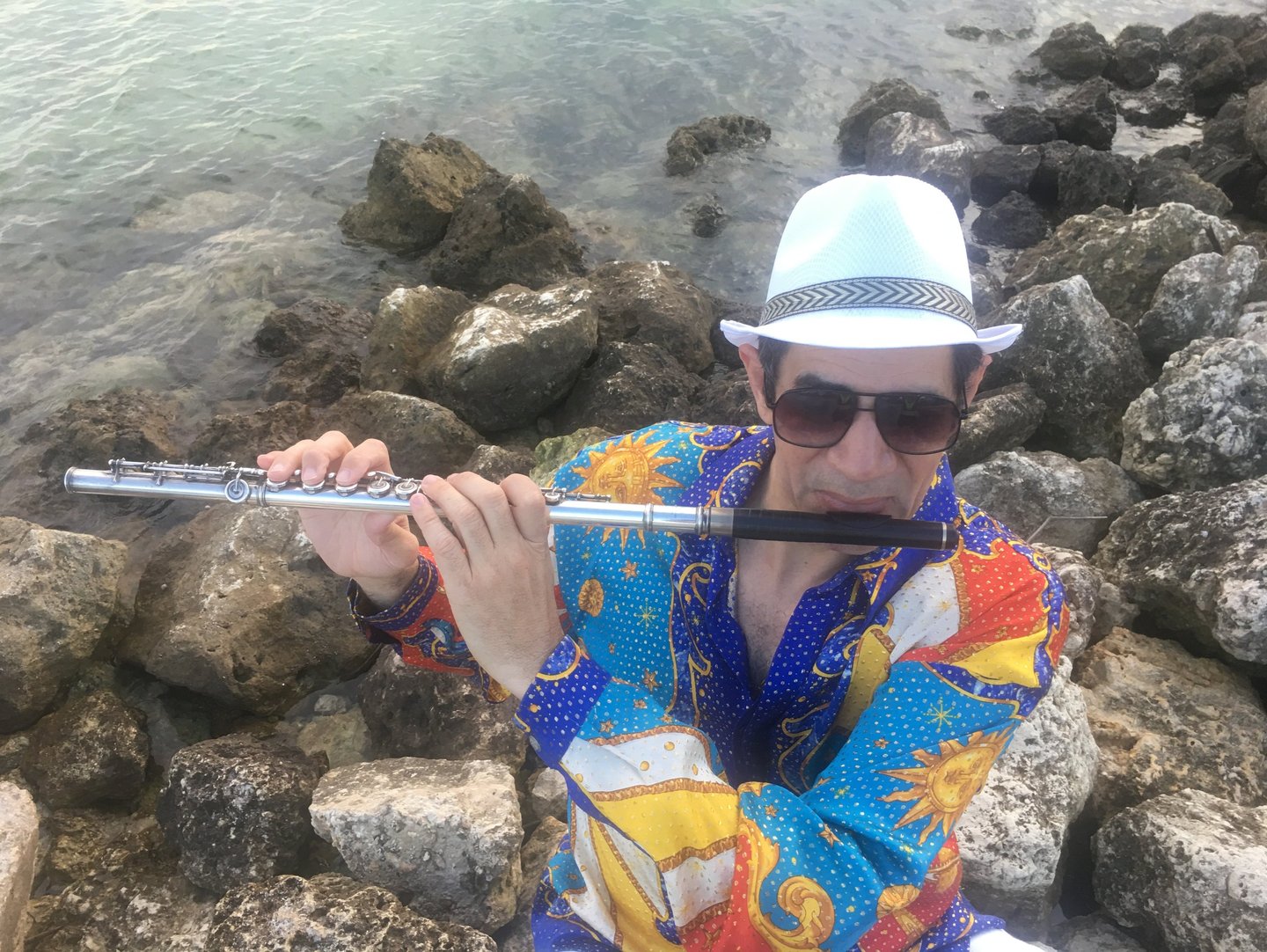 Bobby Ramirez playing flutewearing his iconis shirt fom his first CD cover