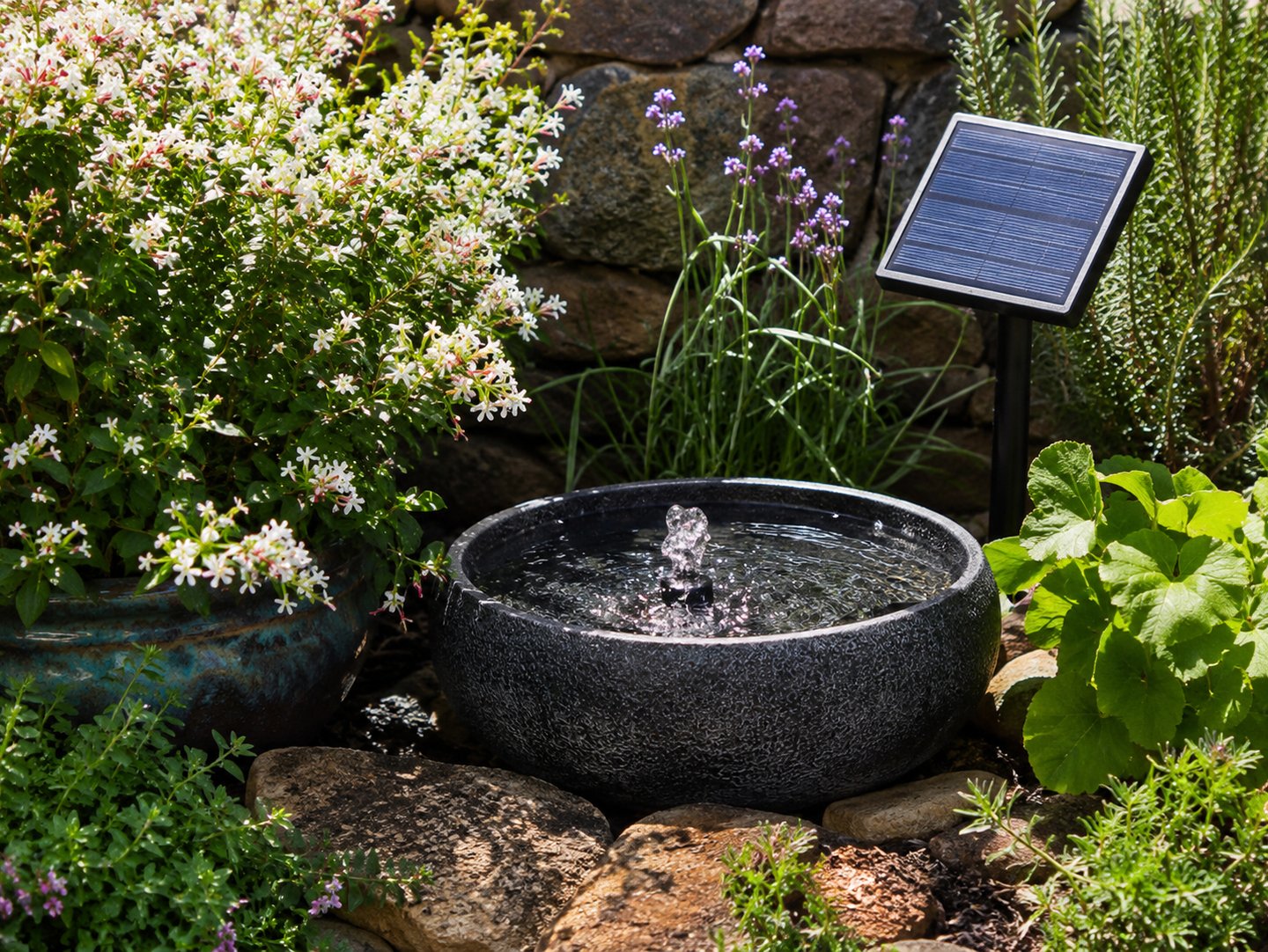 Solar-powered water fountain in a flower garden