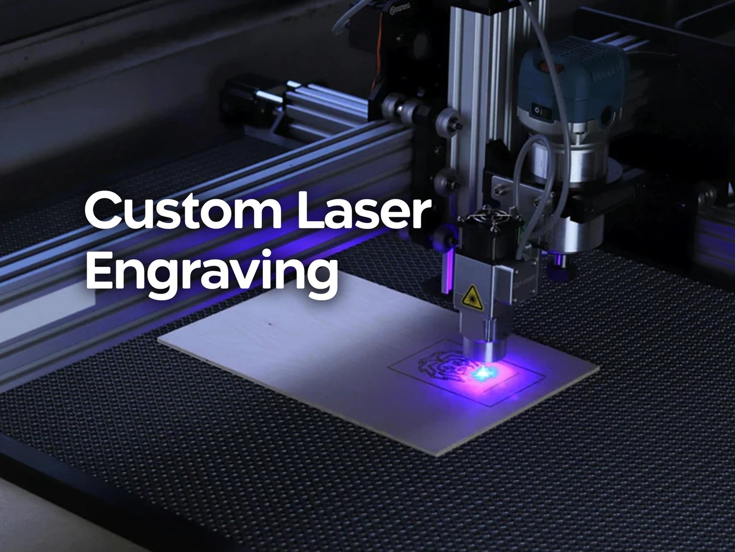 Laser engraver etching wood with blue light. Custom engraving services for signage and merch.