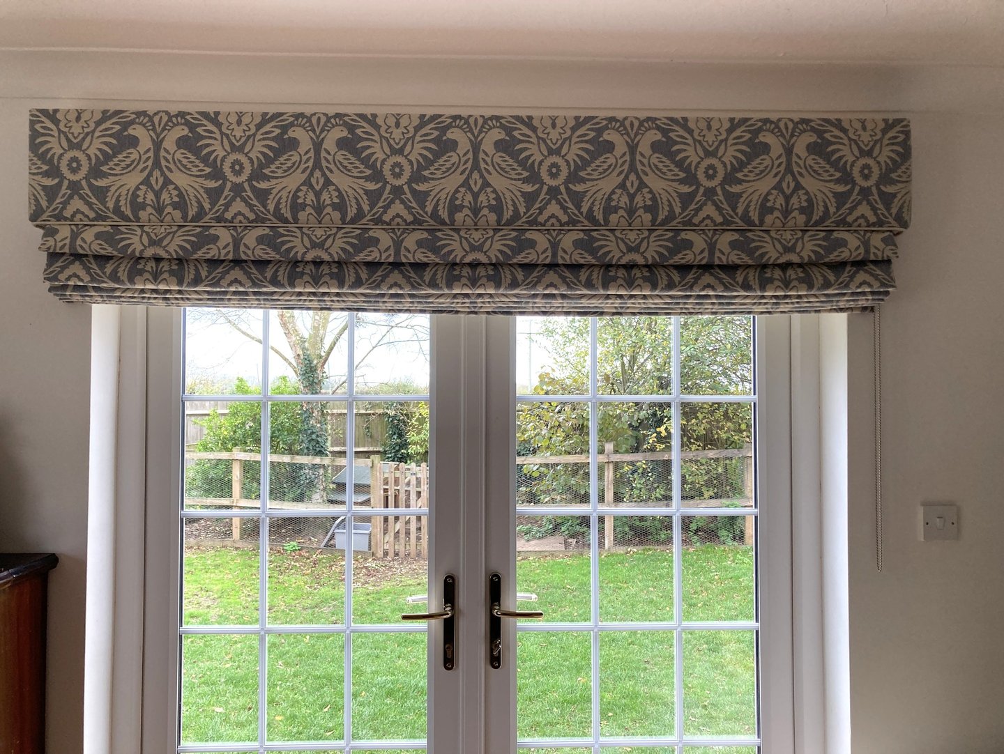 A large blind with a solid fabric in the same fabric which is carefully pattern matched