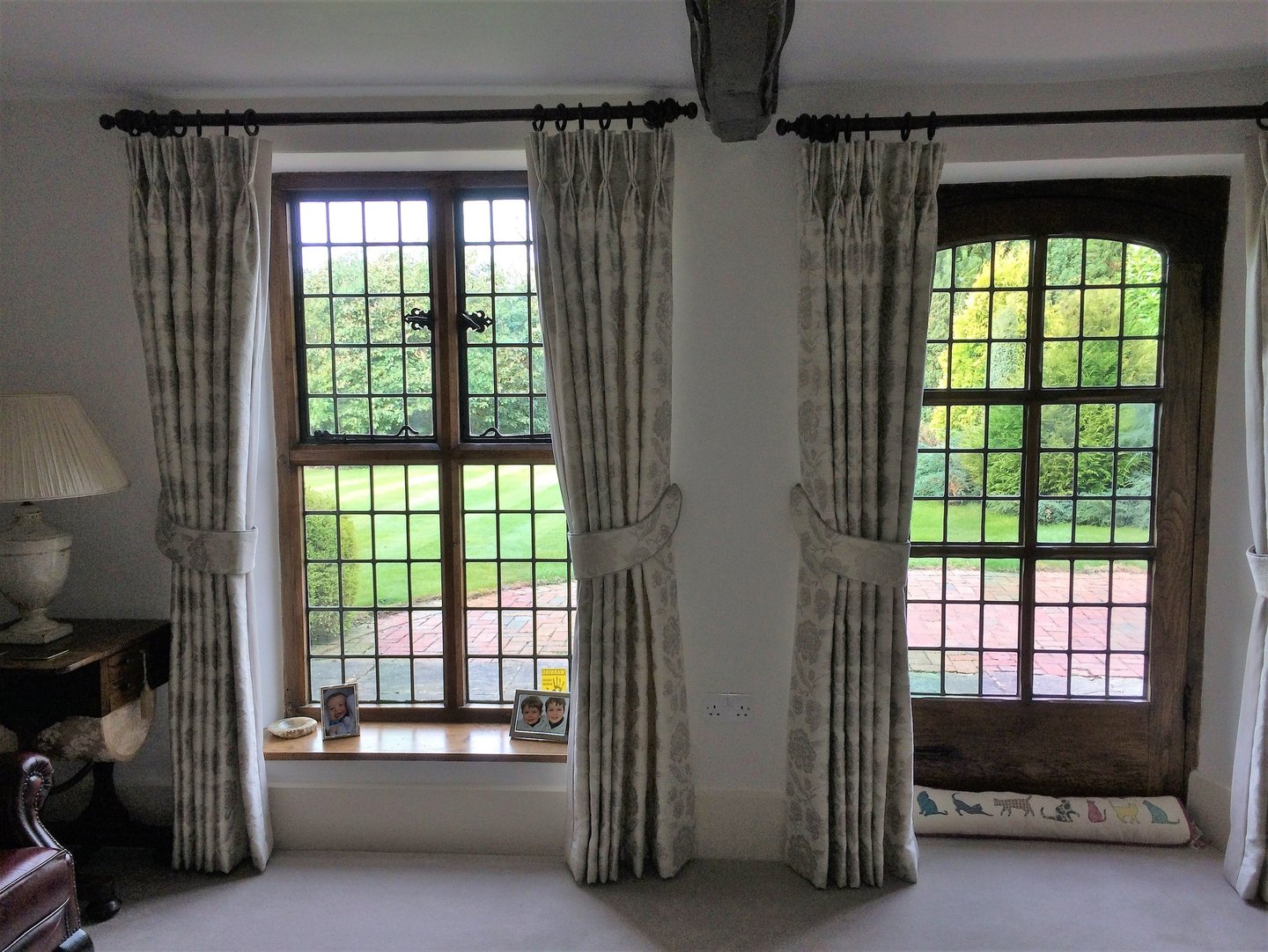 Bespoke curtains with double pleats and padded tie backs in the same fabric