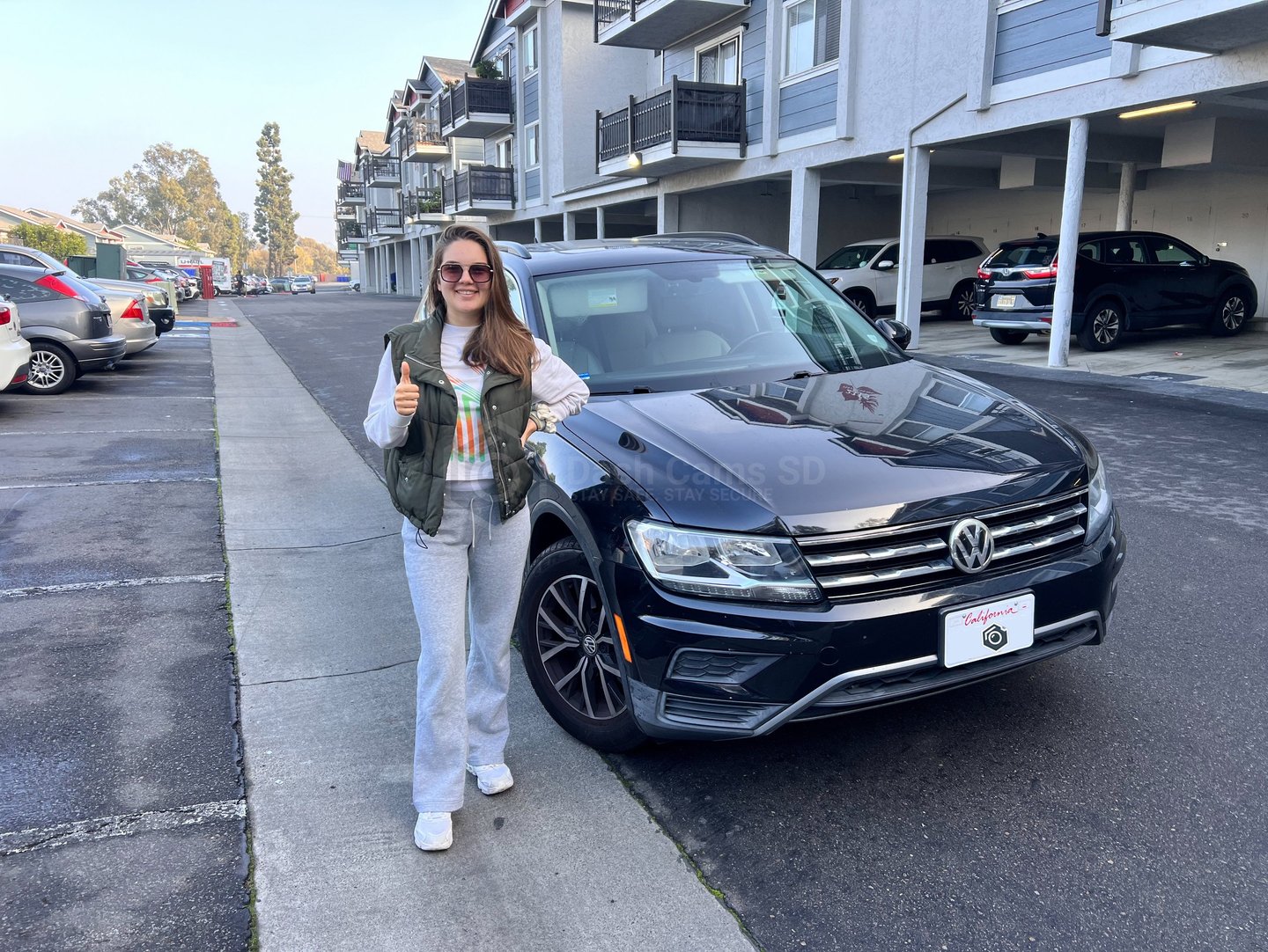Girl standing in front of volkswagen Tiguan 2019 car