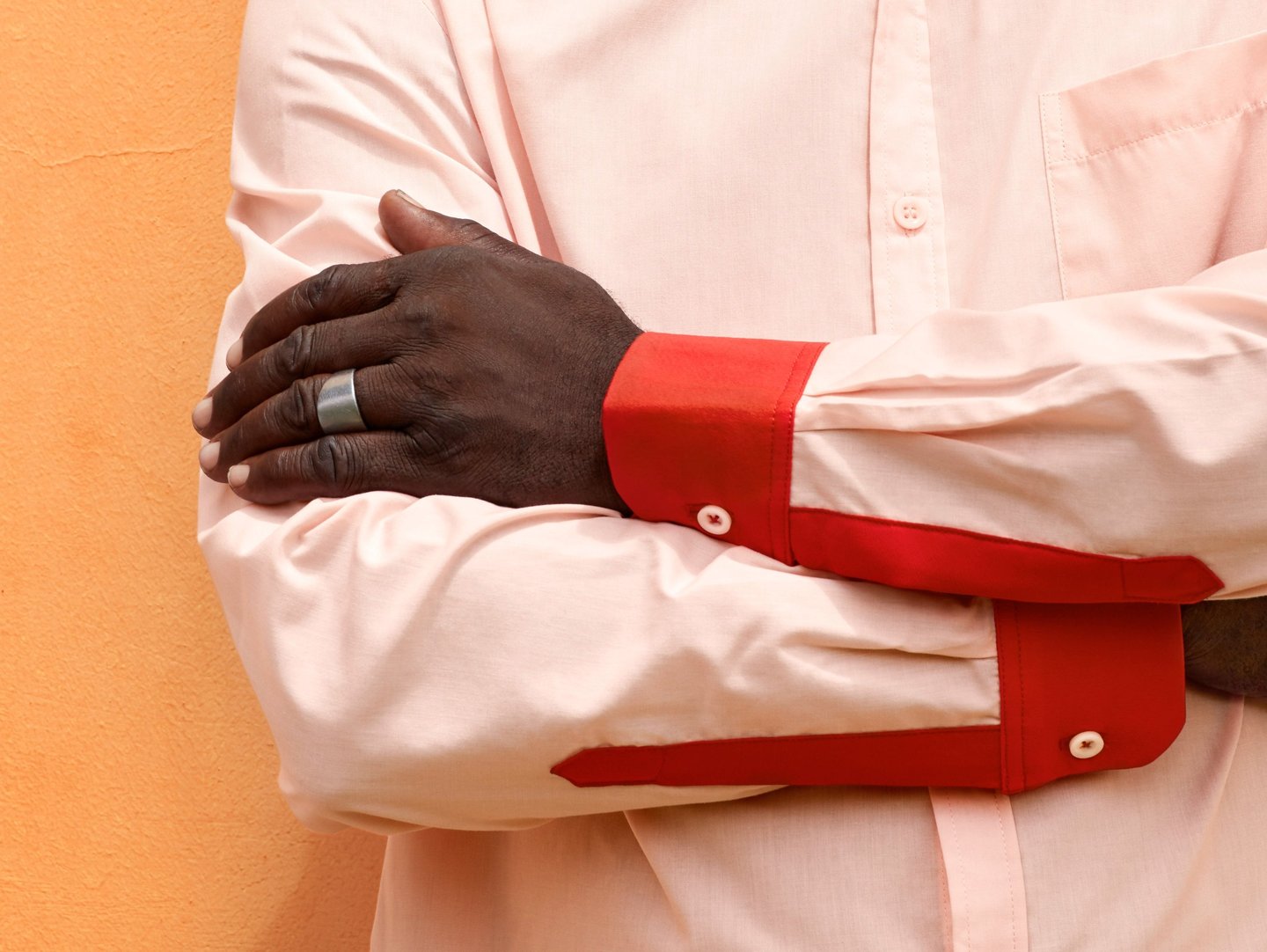 a man in a white shirt and red tie dye