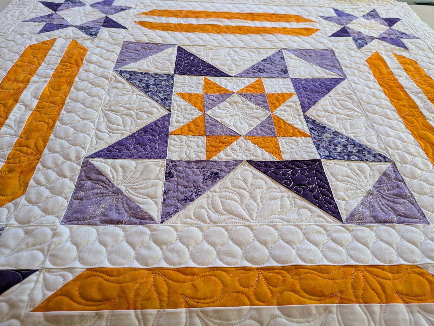 part of an orange and purple quilt